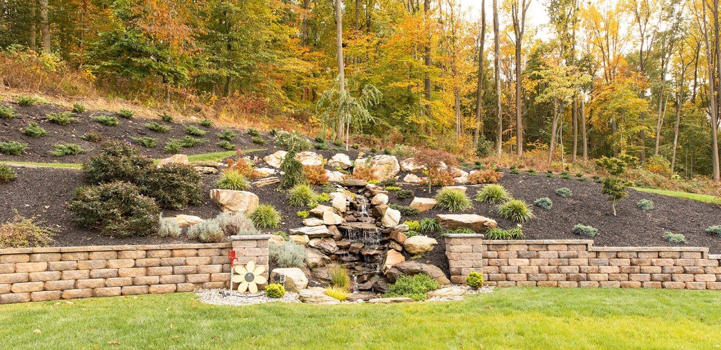 retaining wall with water feature and landscaping